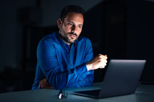 Counselor preparing a student application on a laptop
