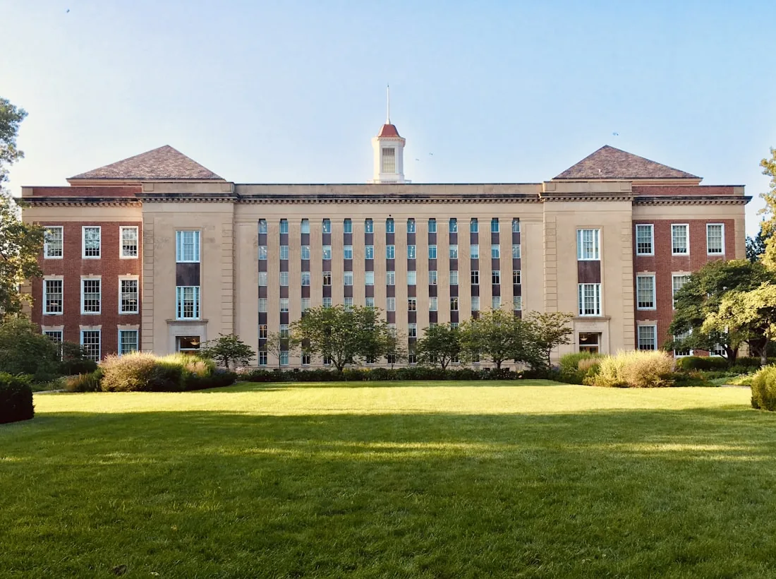 Historic university campus building surrounded by lawns